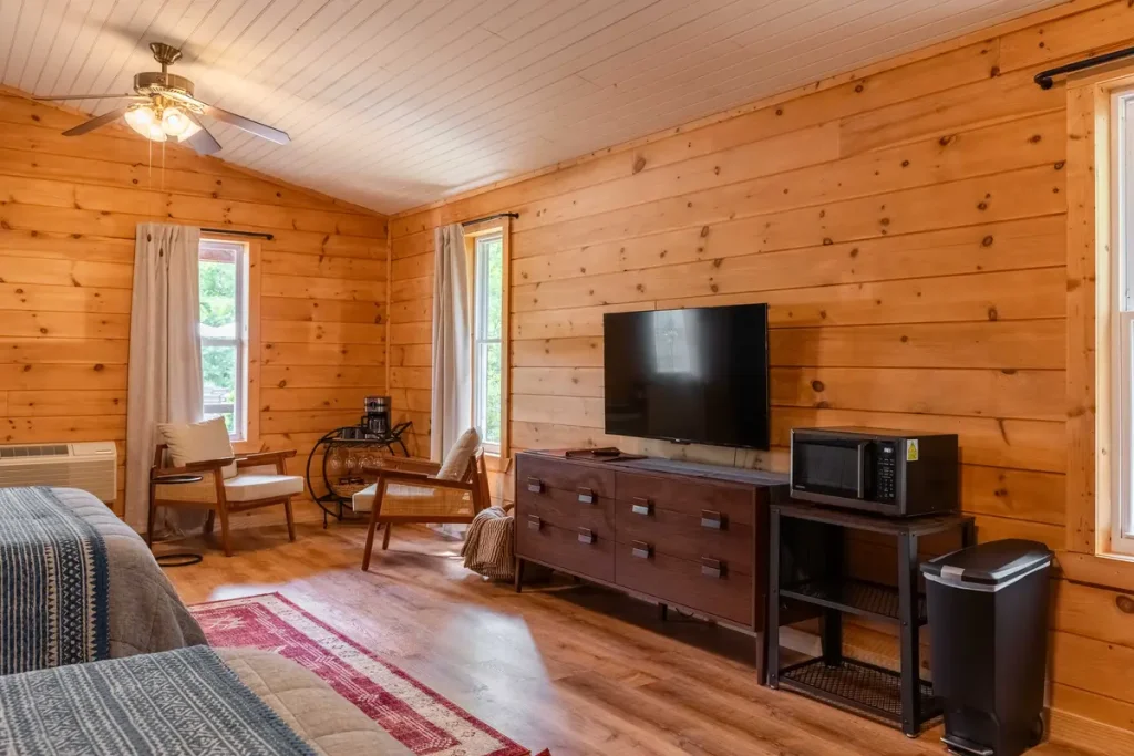 Room view with TV, dresser, and two queen beds inside Garden Studio A at The Shaded Crest in Lake Lure, North Carolina