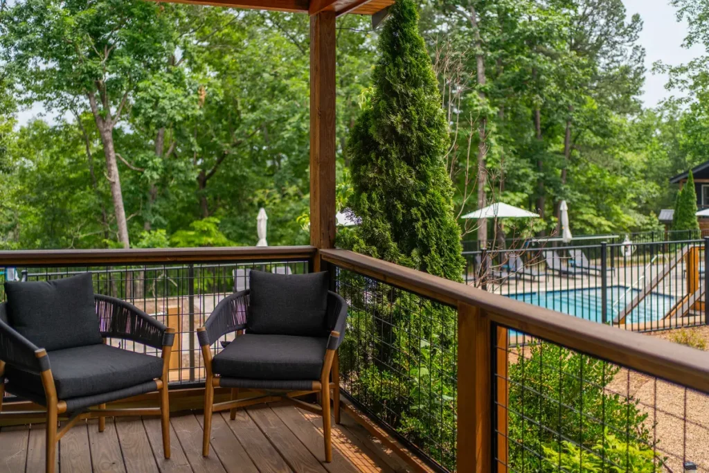Shared porch seating with pool view outside Garden Studio B at The Shaded Crest in Lake Lure, North Carolina