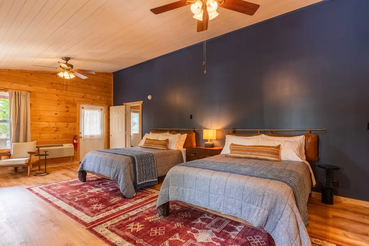 Wide studio view with two queen beds inside Garden Studio B at The Shaded Crest in Lake Lure, North Carolina