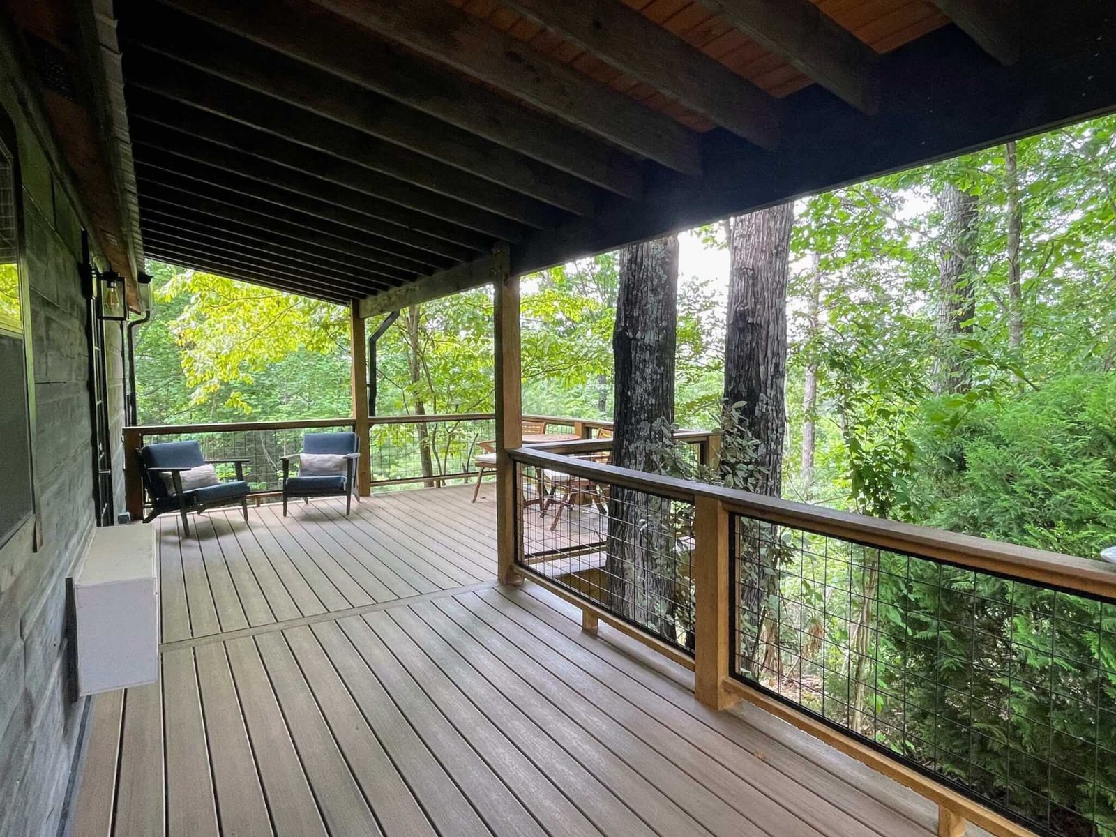 Covered deck surrounded by nature.