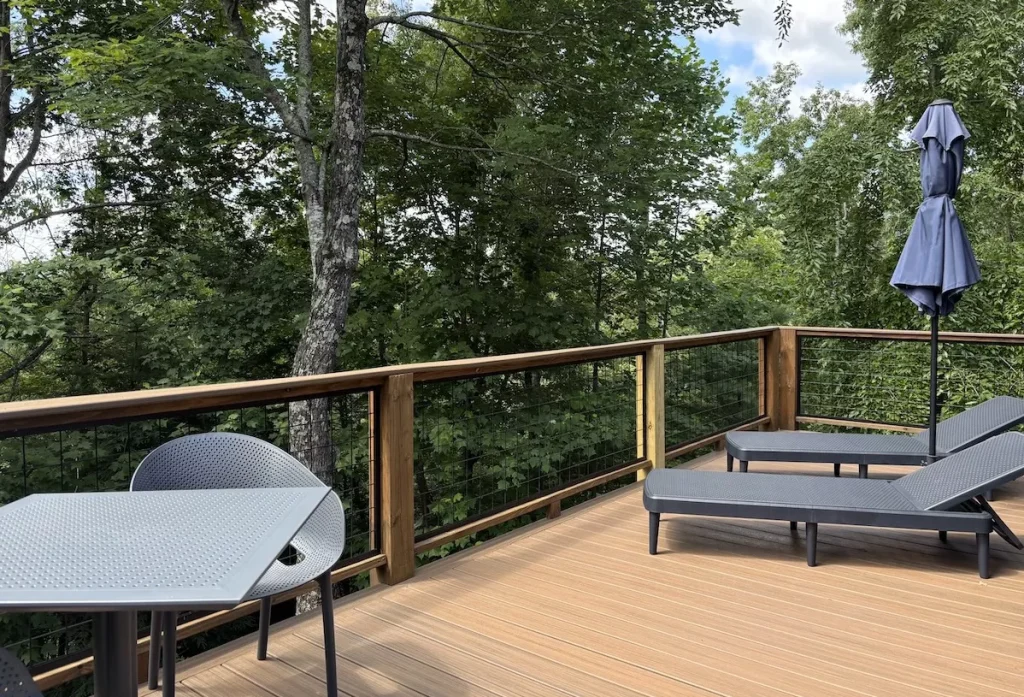 Private back deck with loungers and forest view at The Perch cabin at The Shaded Crest in Lake Lure, North Carolina