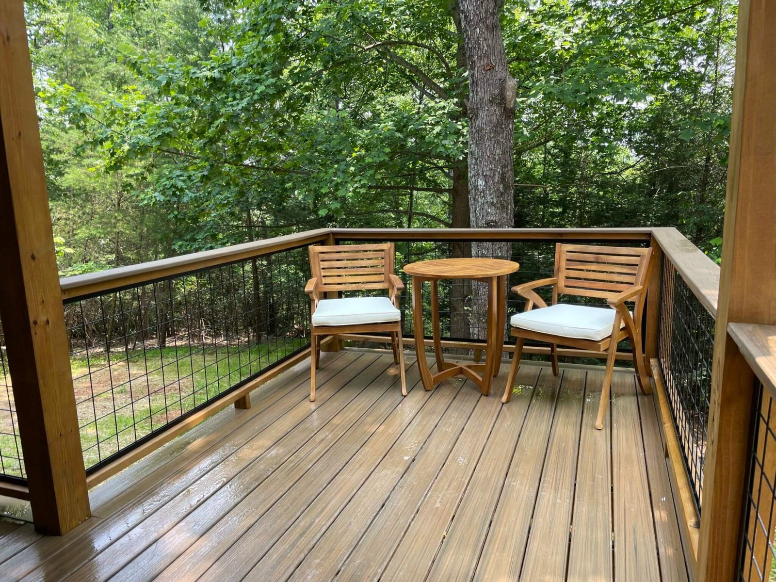 Alfresco dining on the extended deck that is open-air surrounded by nature.