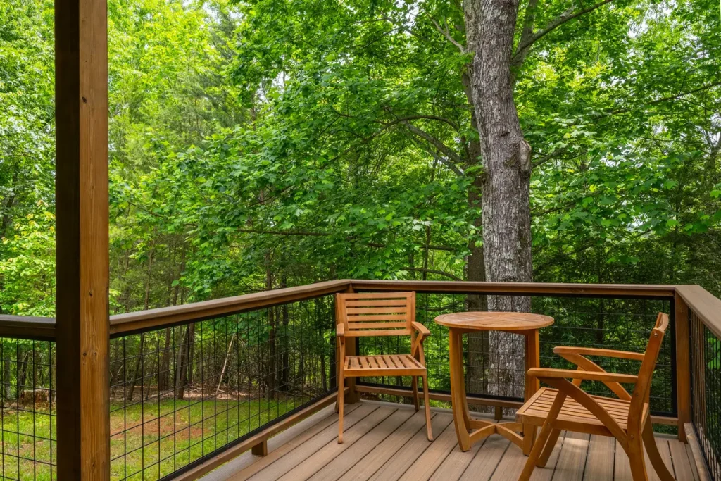 Private deck with forest view outside The Snug cabin in Lake Lure, North Carolina